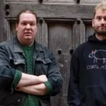 two men standing in front of a door