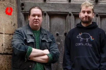 two men standing in front of a door